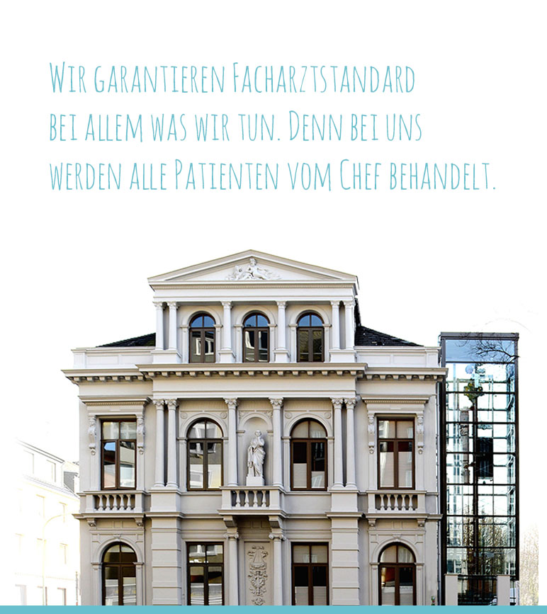 Die große weiße Villa Seedorf mit großen Fenstern über drei Etagen und einem gläsernen Aufzug auf der rechten Seite.